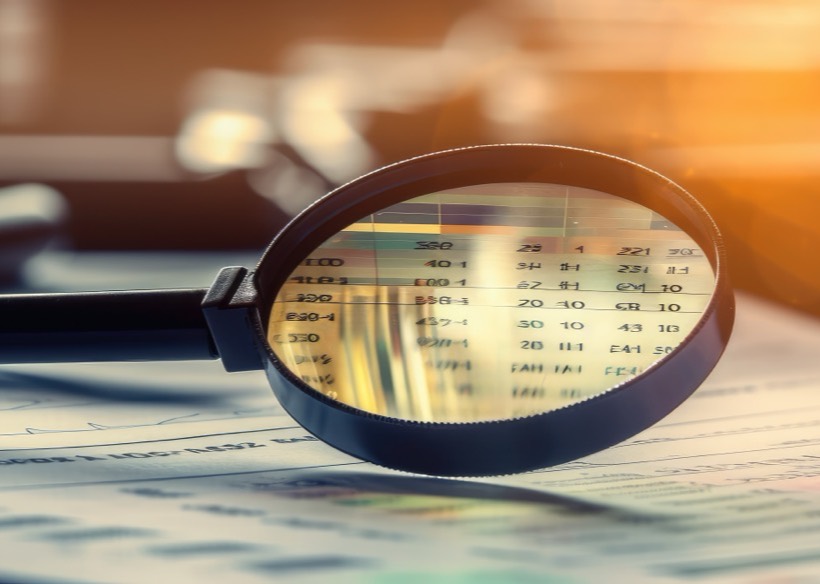 Financial documents examined under a magnifying glass