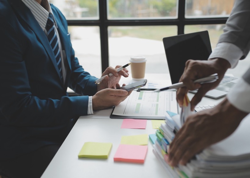 Advisors discussing business strategy over financial reports